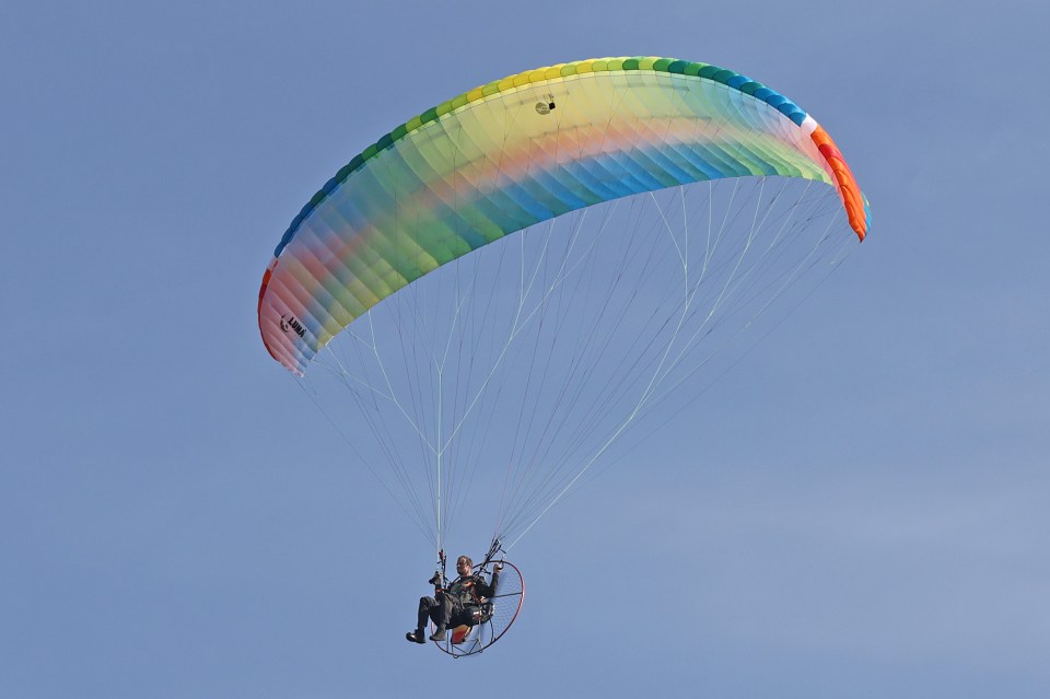 Former SAS man Bear Grylls was spotted paragliding over crocodile infested waters