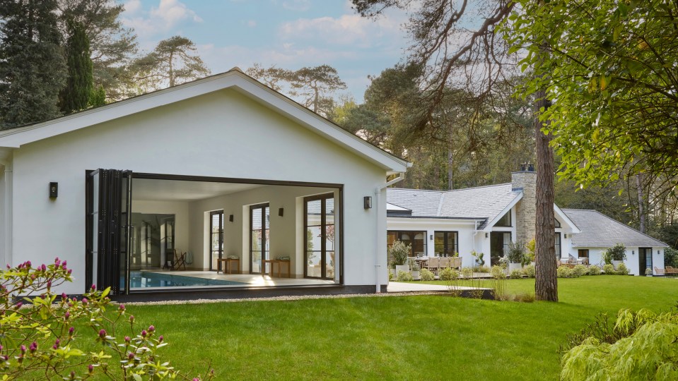 a white house with a swimming pool in the backyard