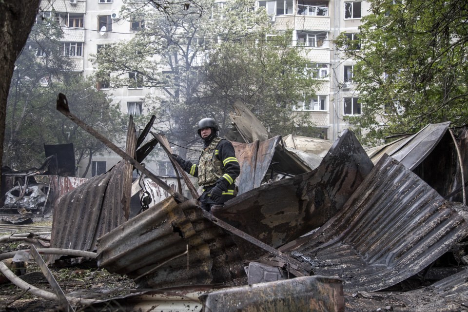 Firefighters are seen working to put off fire on a residential area of Kharkiv on Tuesday