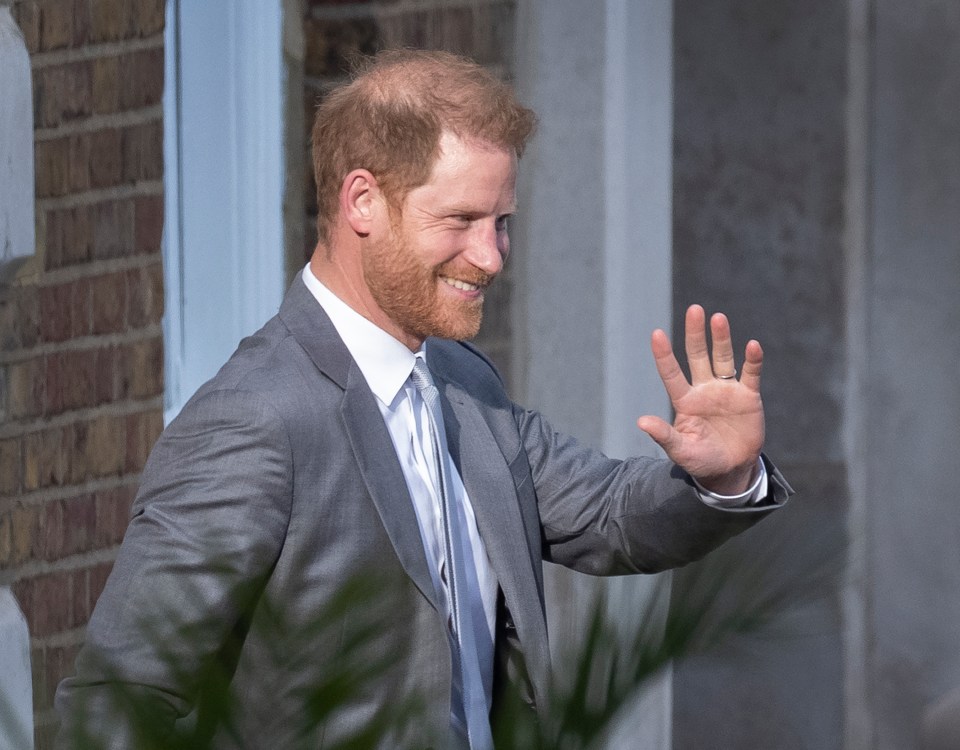 Prince Harry smiles as he leaves the Honourable Artillery Company