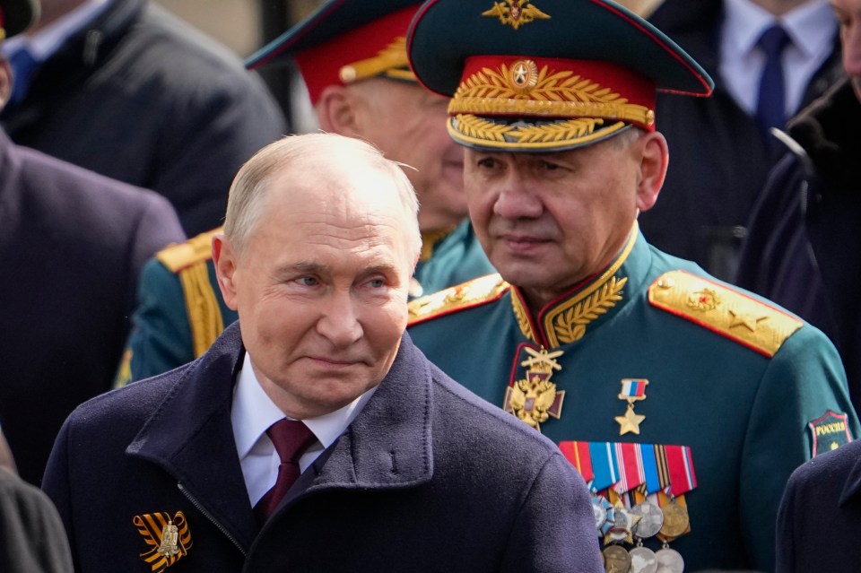 Vladimir Putin is pictured with former Defence Minister Sergei Shoigu at Russia’s Victory Parade on May 9