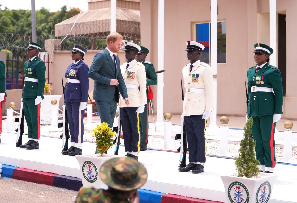 Prince Harry inspects a guard of honour upon his arrival at the Defence headquarters