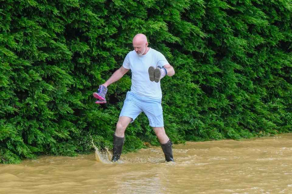 A man was forced to put on his Wellington boots as he waded through flood water