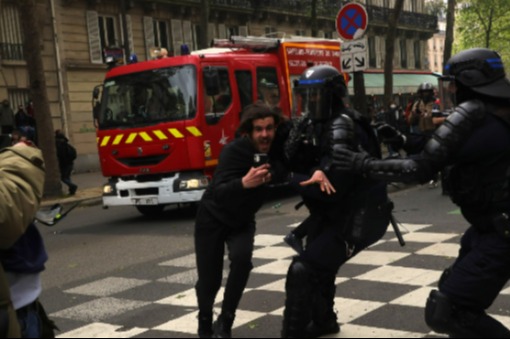 Here cops with batons try to contain a man