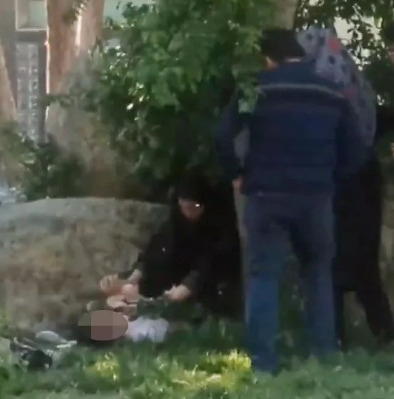 Sickening footage shows the older woman attacking a teen as she lies on the ground