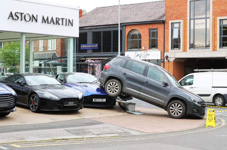 A VW driver was left red-faced after reversing over a £210,000 Aston Martin