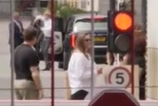 Harry (white shirt, centre) arriving in the UK