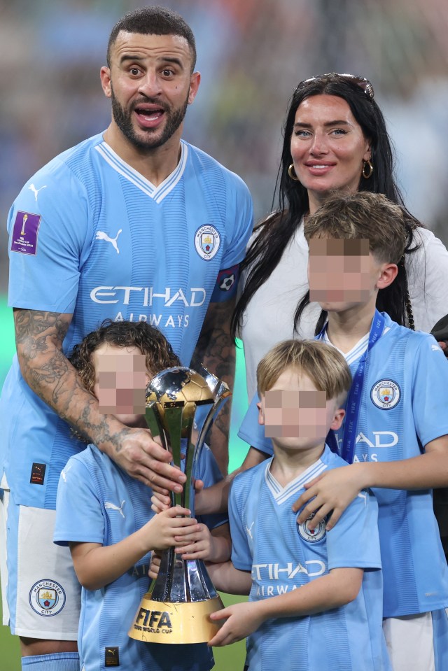 Manchester City's English defender #02 Kyle Walker poses for a picture with his family and trophy after the FIFA Club World Cup final football match between Brazil's Fluminense and England's Manchester City at the King Abdullah Sports City in Jeddah on December 22, 2023. (Photo by AFP) (Photo by -/AFP via Getty Images)