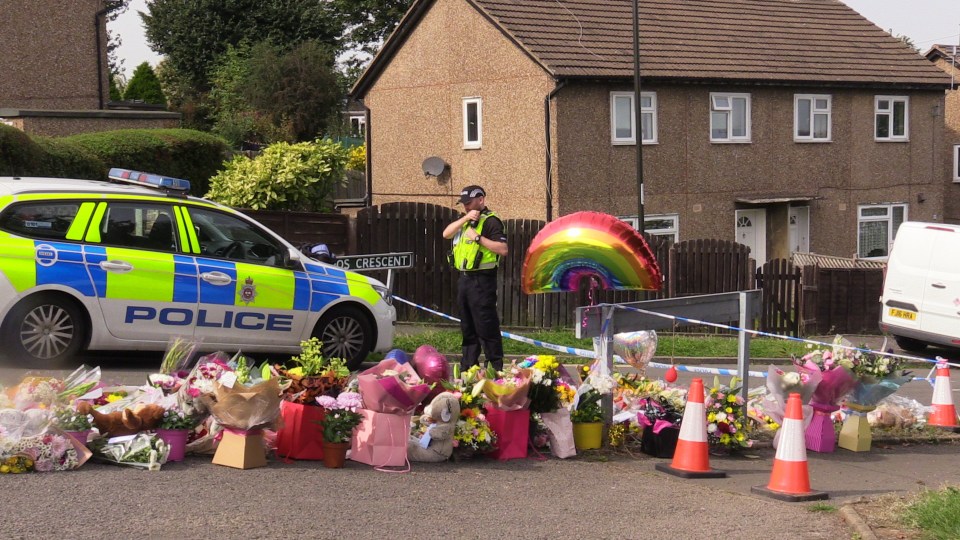 A sea of floral tributes outside the house where the four victims died