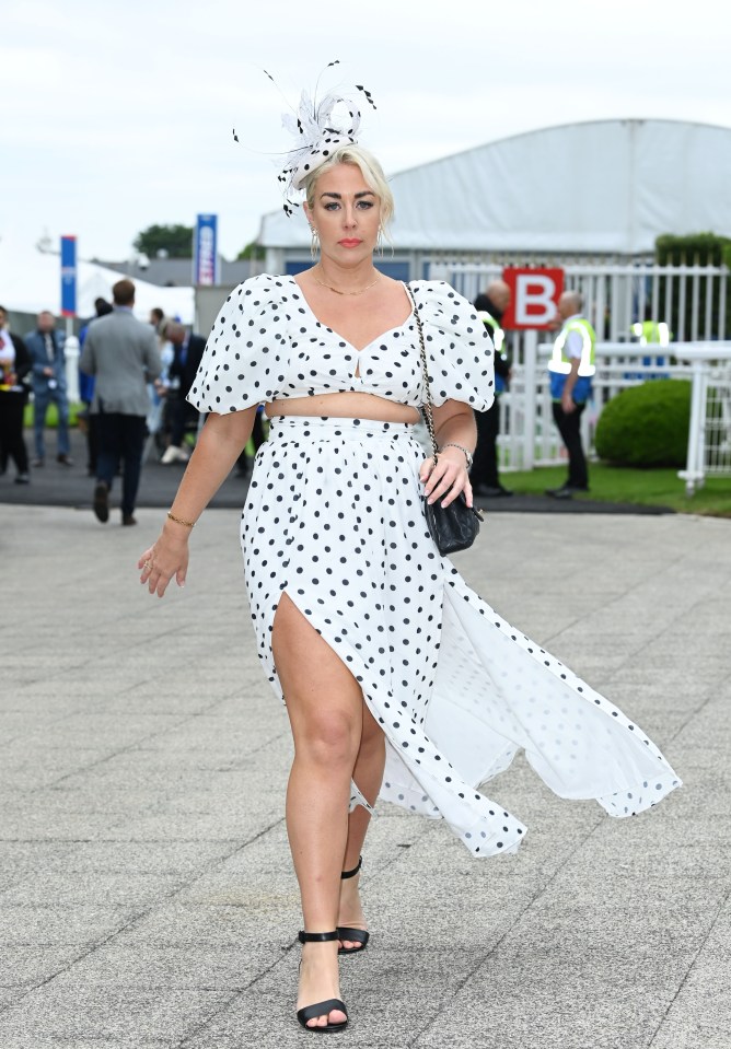 One guest looked chic in polkadots as she arrived for the racing