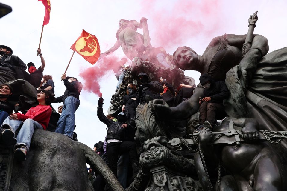 Mandatory Credit: Photo by Tom Nicholson/REX/Shutterstock (14457297ax) Protesters climb a statue as the demonstration marches through Paris on International Labour Day May Day demonstrations, Paris, France - 01 May 2024