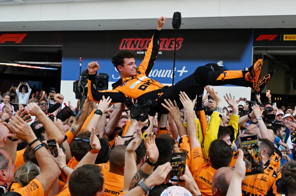 Norris is hoisted in the air after his sensational victory