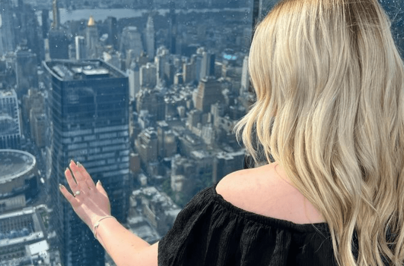 Kayley admired her ring over the New York skyline