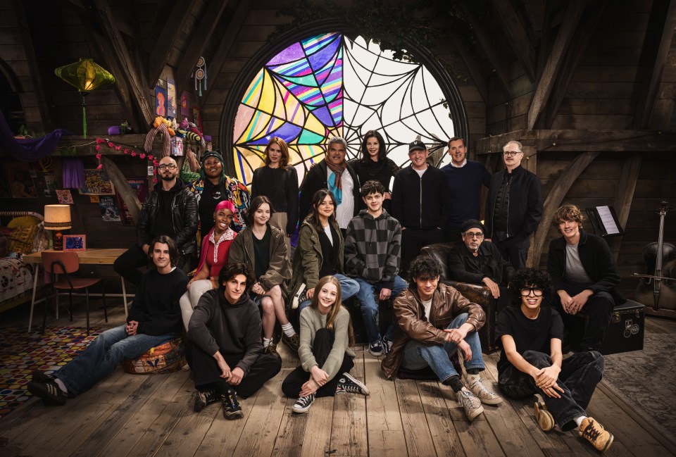 Season two Wednesday cast L-R:  Georgie Farmer, Victor Dorobantu, Luyanda Unati Lewis-Nayo, Joy Sunday, Owen Painter, Emma Myers, Billie Piper, Jenna Ortega, Evie Templeton, Luis Guzmán, Isaac Ordonez, Catherine Zeta-Jones, Alfred Gough, Noah Taylor, Miles Millar, Tim Burton, Steve Buscemi, Moosa Mostafa, Hunter Doohan