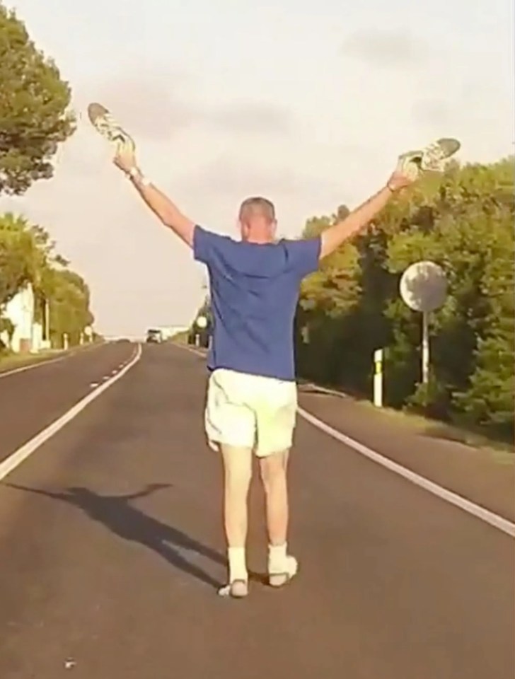 He was seen lifting his arms as a response to the honking of fuming drivers