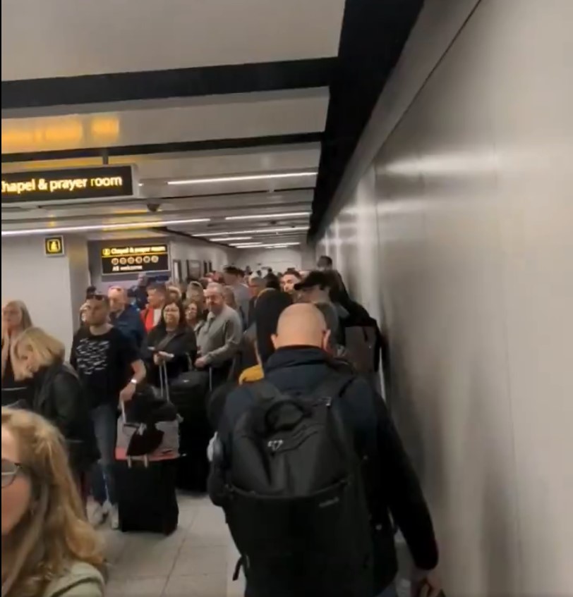 Passengers clutching their belongings as they are asked to leave