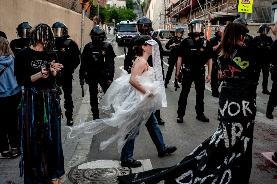 Protesters wear expressive clothing including a wedding dress made of plastic