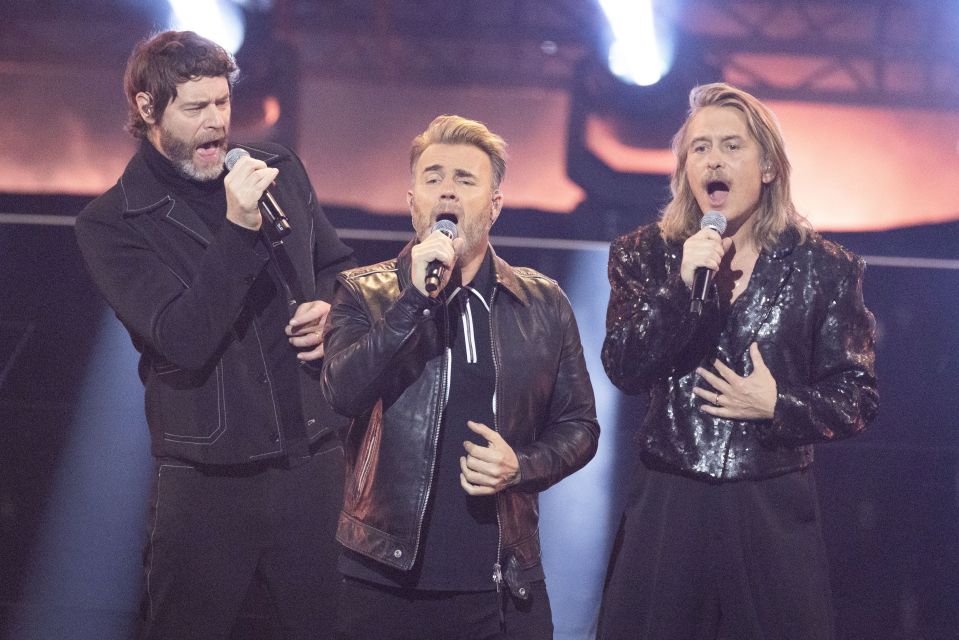 OFFENBURG, GERMANY - NOVEMBER 25: Howard Donald, Gary Barlow and Mark Owen of Take That perform on stage during the "Wetten, Dass ...?" tv show on November 25, 2023 in Offenburg, Germany.  (Photo by Andreas Rentz/Getty Images)