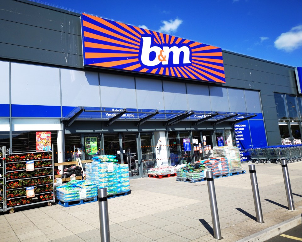 Swansea, UK: July 03, 2019: B&M Bargains retail shop front with merchandise and bargain items displayed outside.