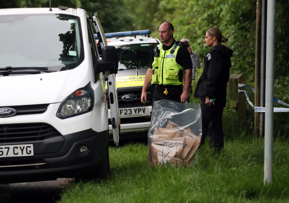 Police forensic officers gather evidence