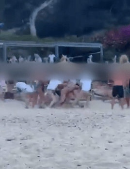 The moment the brawl broke out on the beach