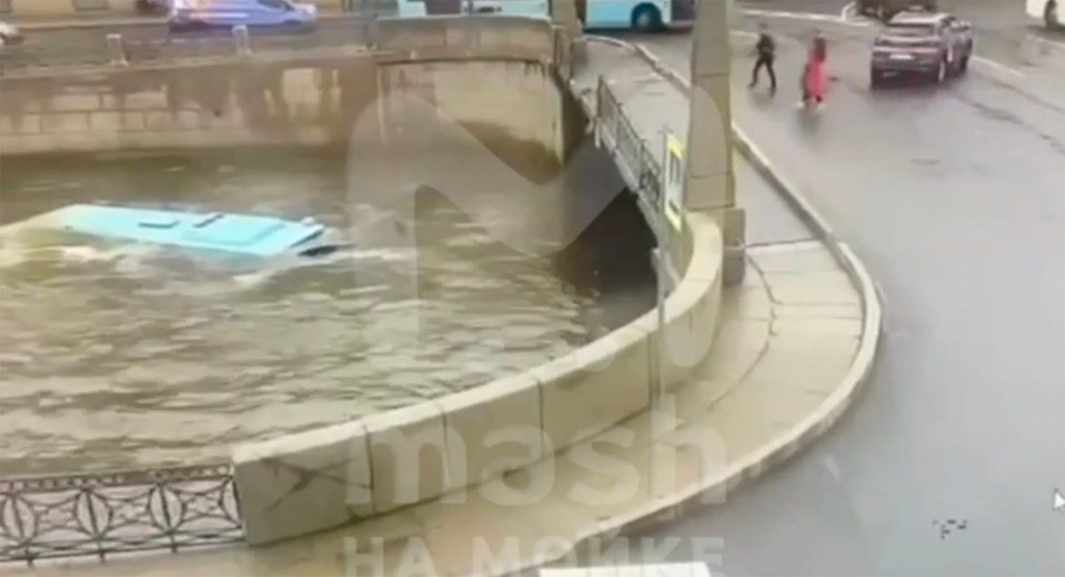 The bus can be seen entirely submerged in the water after smashing the side of the bridge