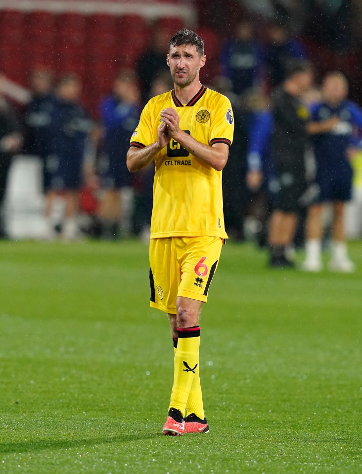 a soccer player wearing a yellow jersey with the number 6 on it