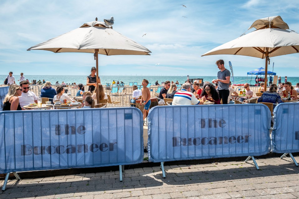 Crowds gathering on Brighton beach to enjoy the sun