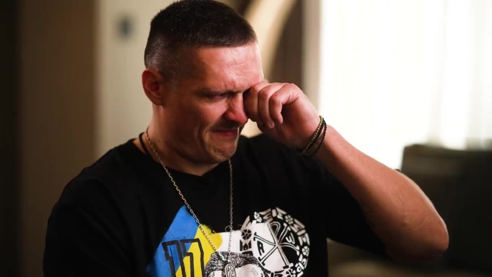 Oleksandr Usyk crying, wiping tears from his eyes.