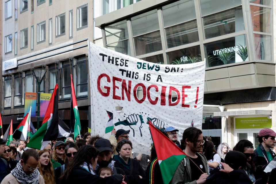 Demonstrators carry a banner in protest against Israeli participation in the Eurovision Song Contest