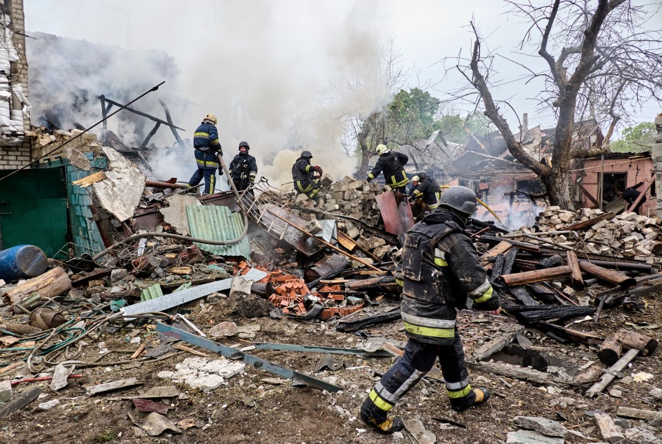 Ukrainian rescuers work on the site after a glide bomb hit a building in the Kharkiv area