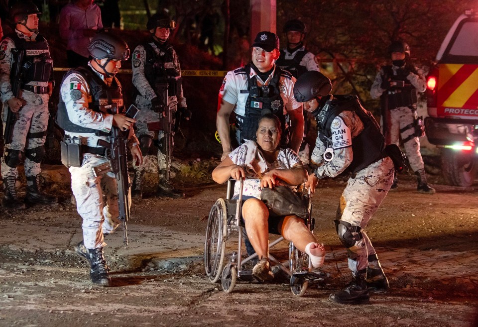 Soldiers help a woman injured in the incident