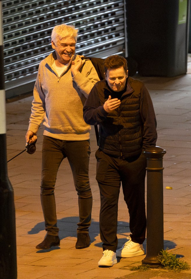 The pair of jokers share a laugh on the street in London