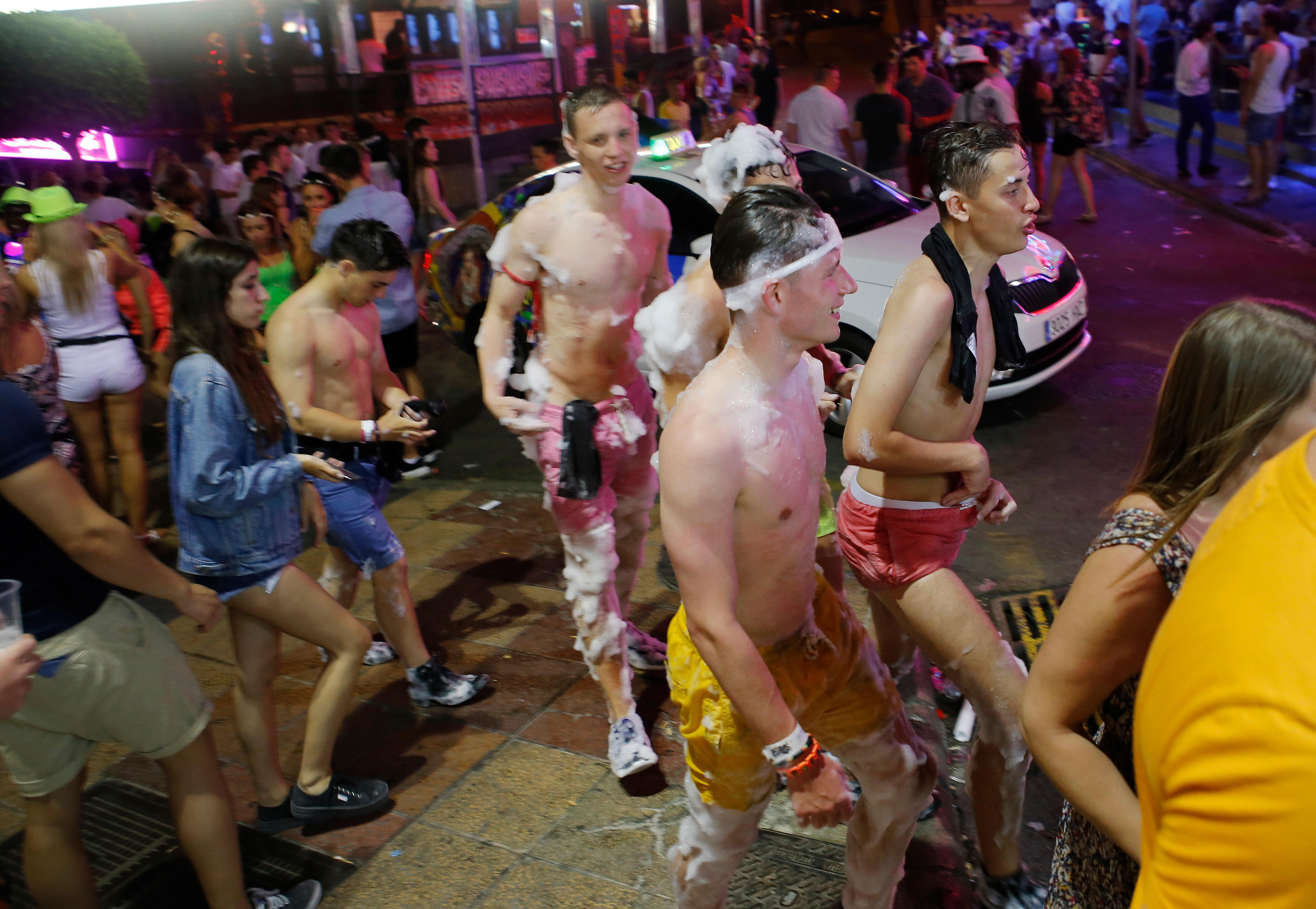 Young Brit tourists covered in foam while enjoying a holiday on the Spanish island