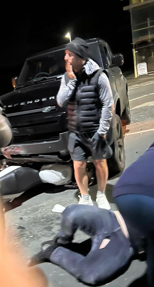 Our pictures show the Man Utd legend looking concerned moments after the crash involving his £100,000 Land Rover Defender