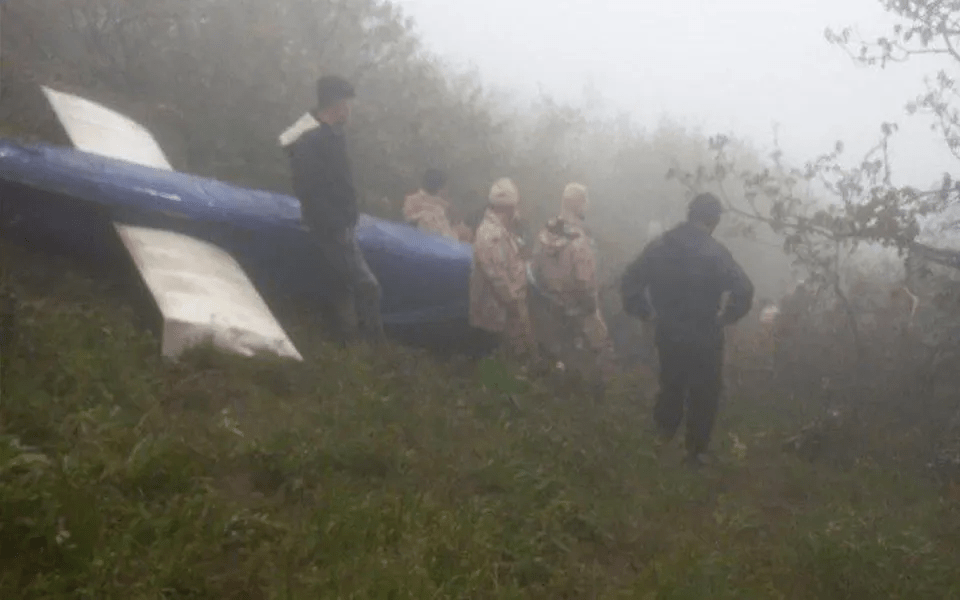 Search and rescue personnel survey the site of the helicopter crash