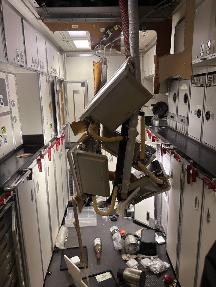 Pipes hang from the roof after the plane plunged 7,000ft