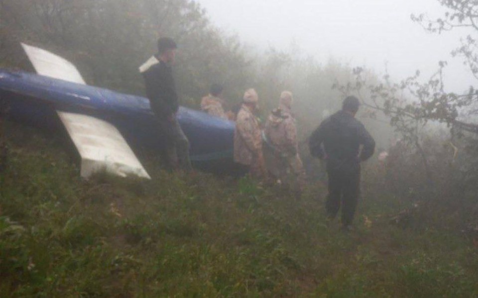 Search and rescue personnel survey the site of the helicopter crash that killed Iran's president and foreign minister