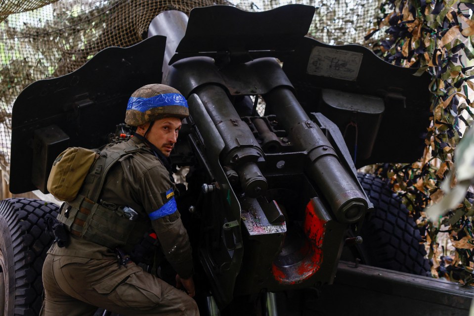 A service member of the National Guard of Ukraine prepares to fire towards Russian troops