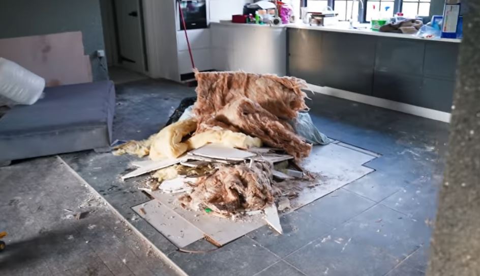 Piles of debris on the floor of Mucky Mansion