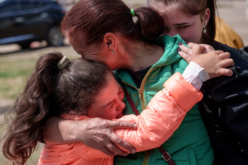 Khrystyna Pyimak, 11, hugs her mother Oksana Velychko, 42, after evacuation from Vovchansk, Ukraine on Sunday