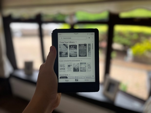 a person is holding a tablet that says from your library on the screen