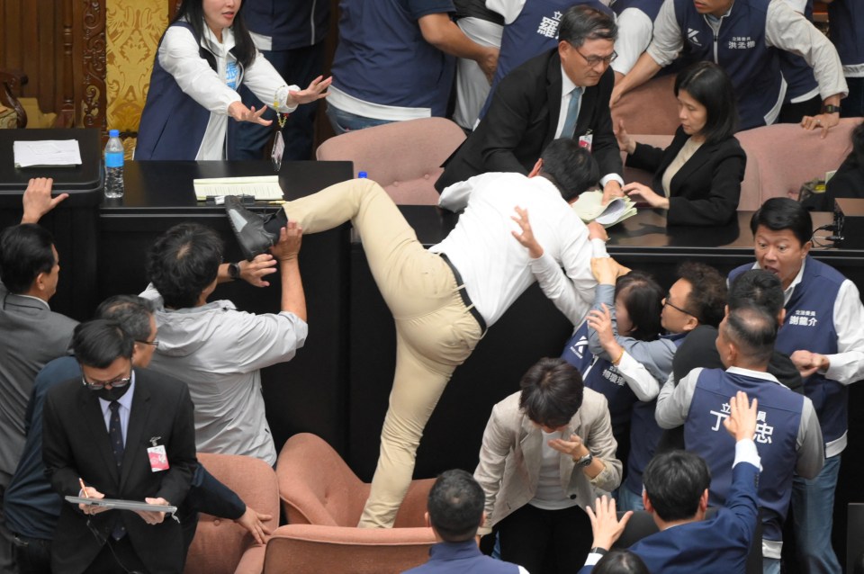 Taiwan’s ruling Democratic Progressive Party (DPP) lawmaker Kuo Kuo Wen trying to jump onto the desk during the voting for the Parliament reform bill