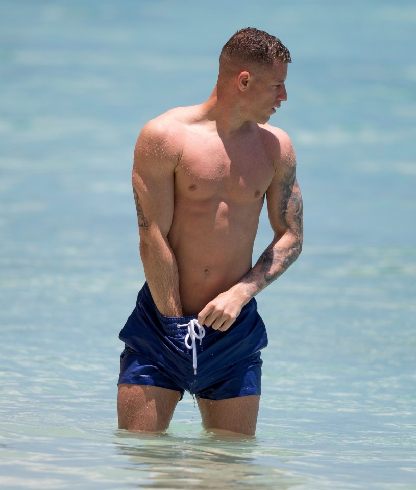 Footballer Ross Barkley flaunted his shredded abs as he took to the beach in sunny Barbados