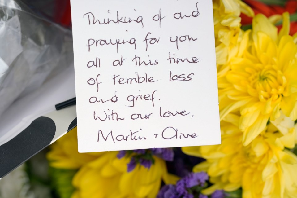 Messages and flowers at the scene of the fatal house fire