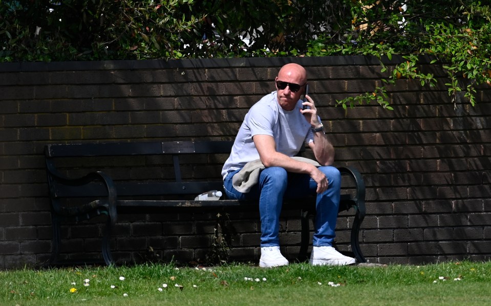 He looked glum as he sat on a park bench