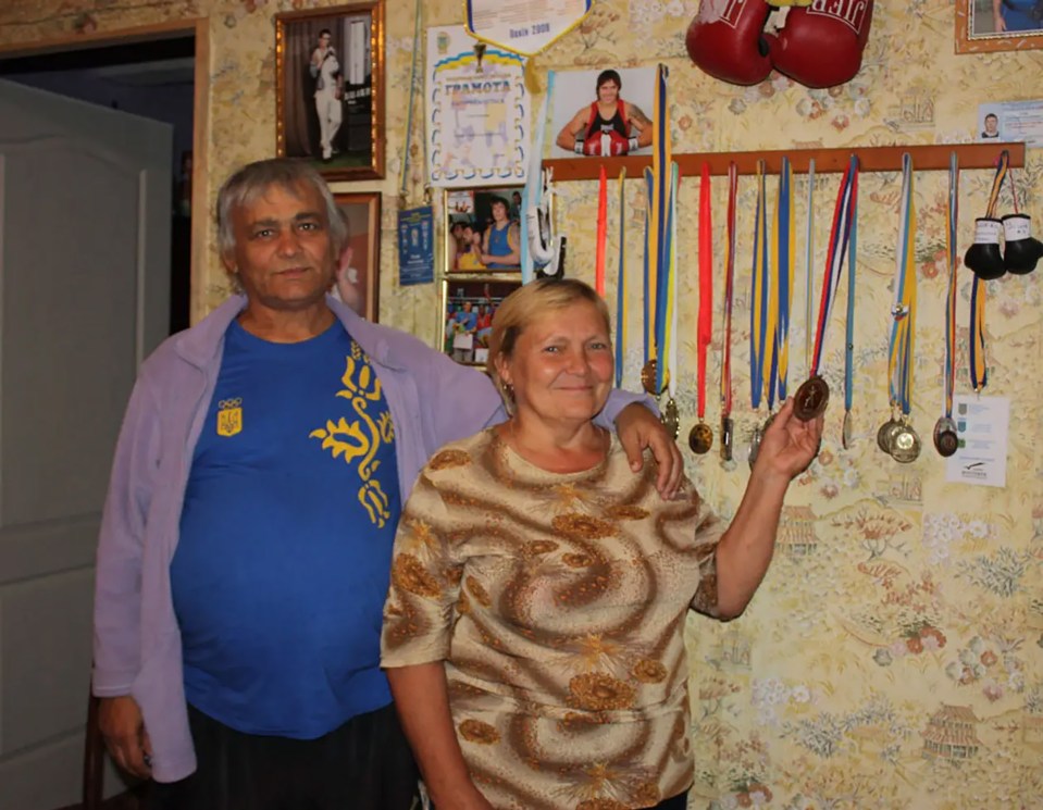 Oleksandr Usyk's parents, Nadezhda and Oleksandr, stand together.