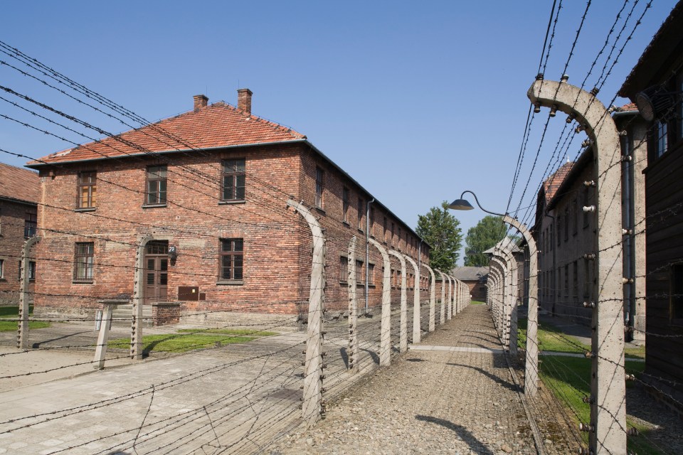 Prison blocks and a double line of electric fencing are seen at Auschwitz