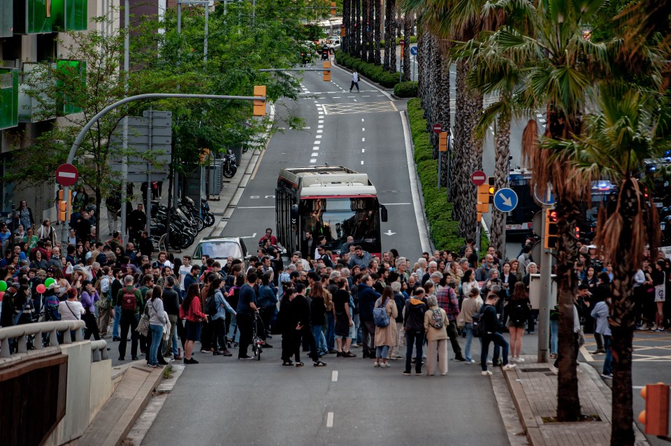 Activists block access to Park Guell, which had been closed off for a Louis Vuitton show