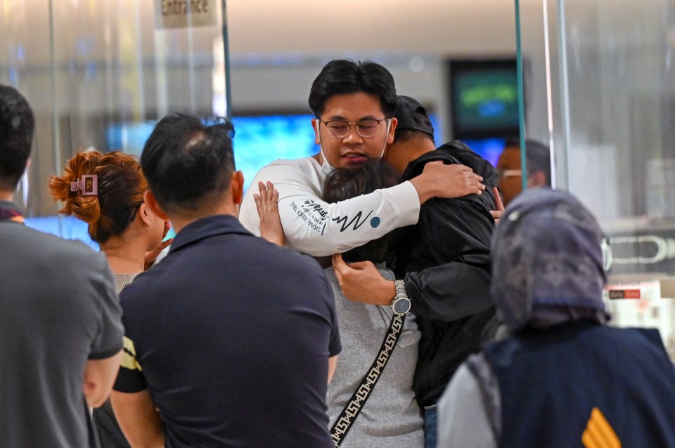 Shell-shocked passengers were seen reuniting with their families after the flight was grounded in Thailand